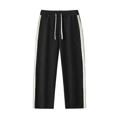 ODMPOD contrast side-stripe straight-leg pants showing a close-up of the black pants with white side stripes.