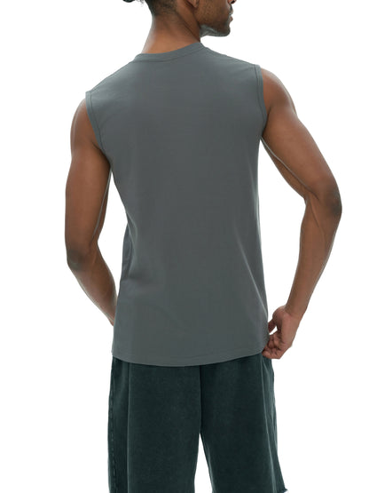 Men's sleeveless cotton tank top by ODMPOD, shown in a solid color with a relaxed fit and round neckline.