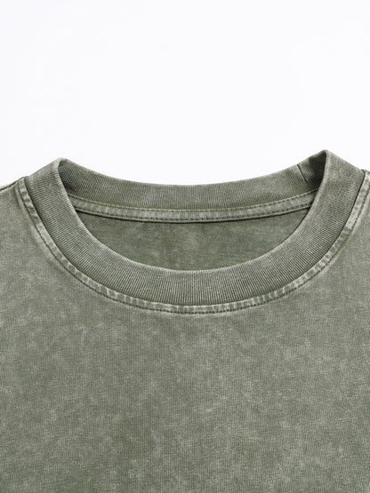 Gray snow-washed heavyweight oversized t-shirt by ODMPOD with a relaxed fit, displayed on a hanger against a neutral background.