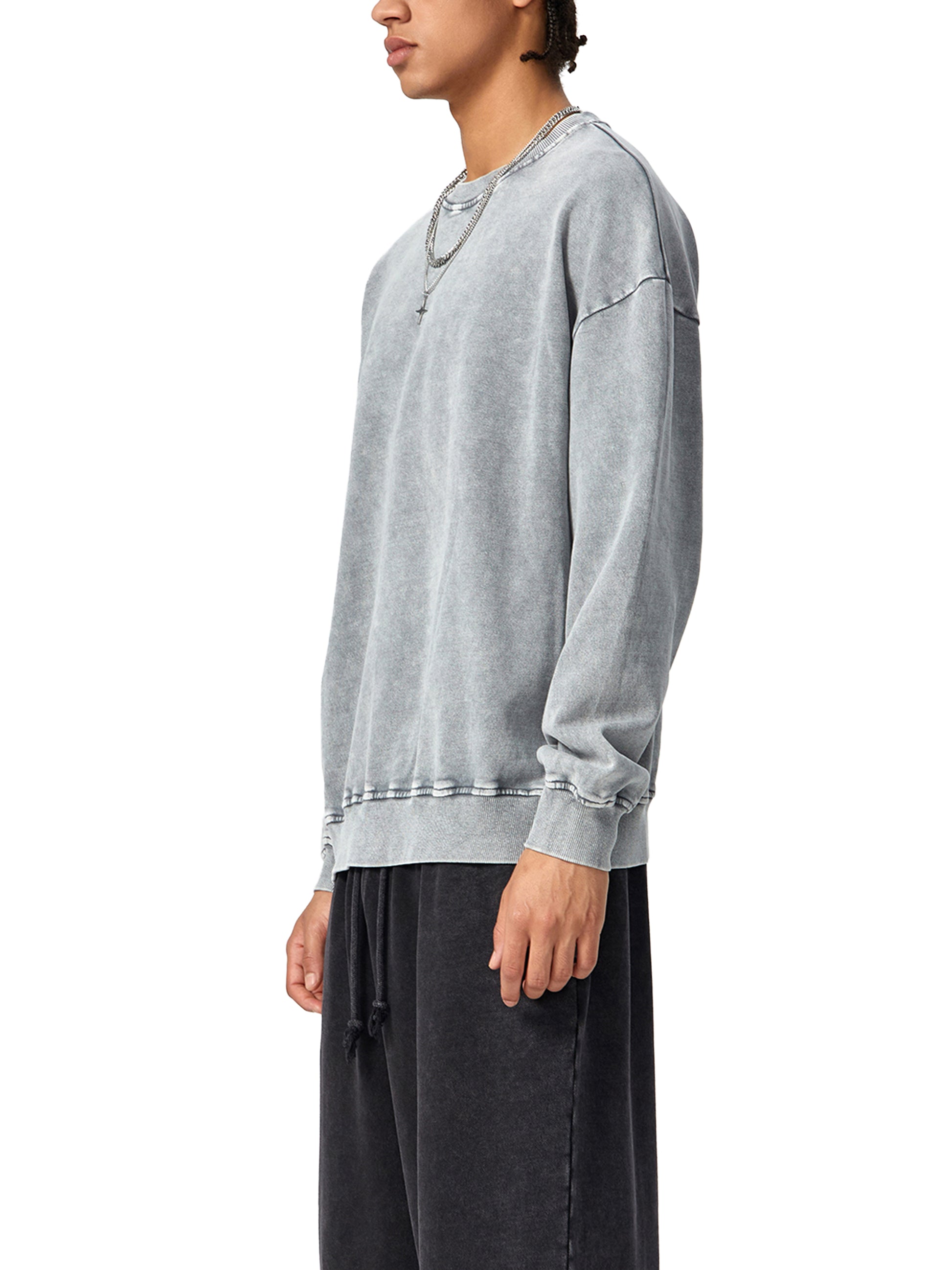 ODMPOD Snow Washed Oversized Sweatshirt in soft, light-colored fabric with a relaxed fit and subtle snow wash texture.