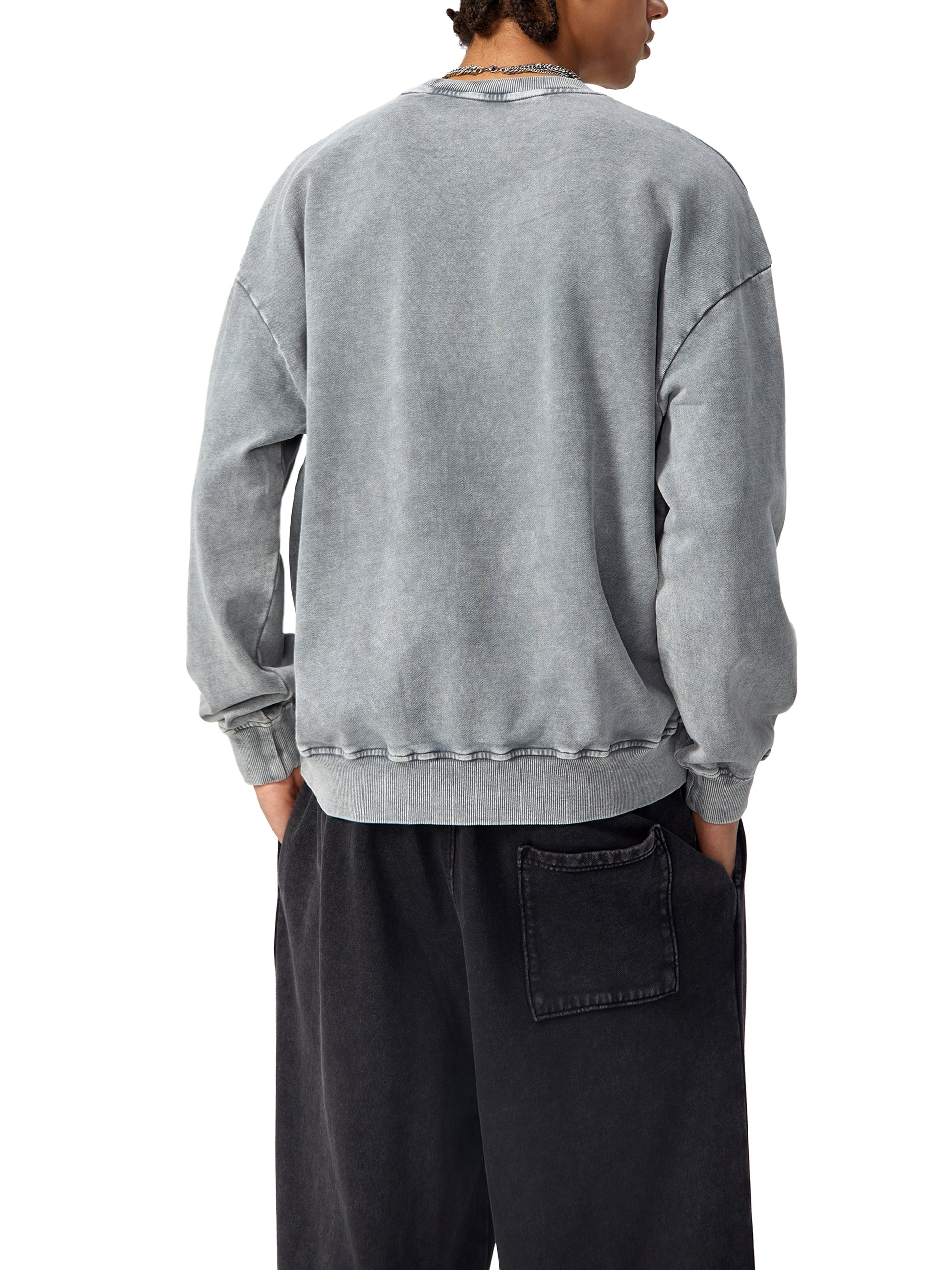 ODMPOD Snow Washed Oversized Sweatshirt shown in light fabric with a relaxed fit and casual style on a model.