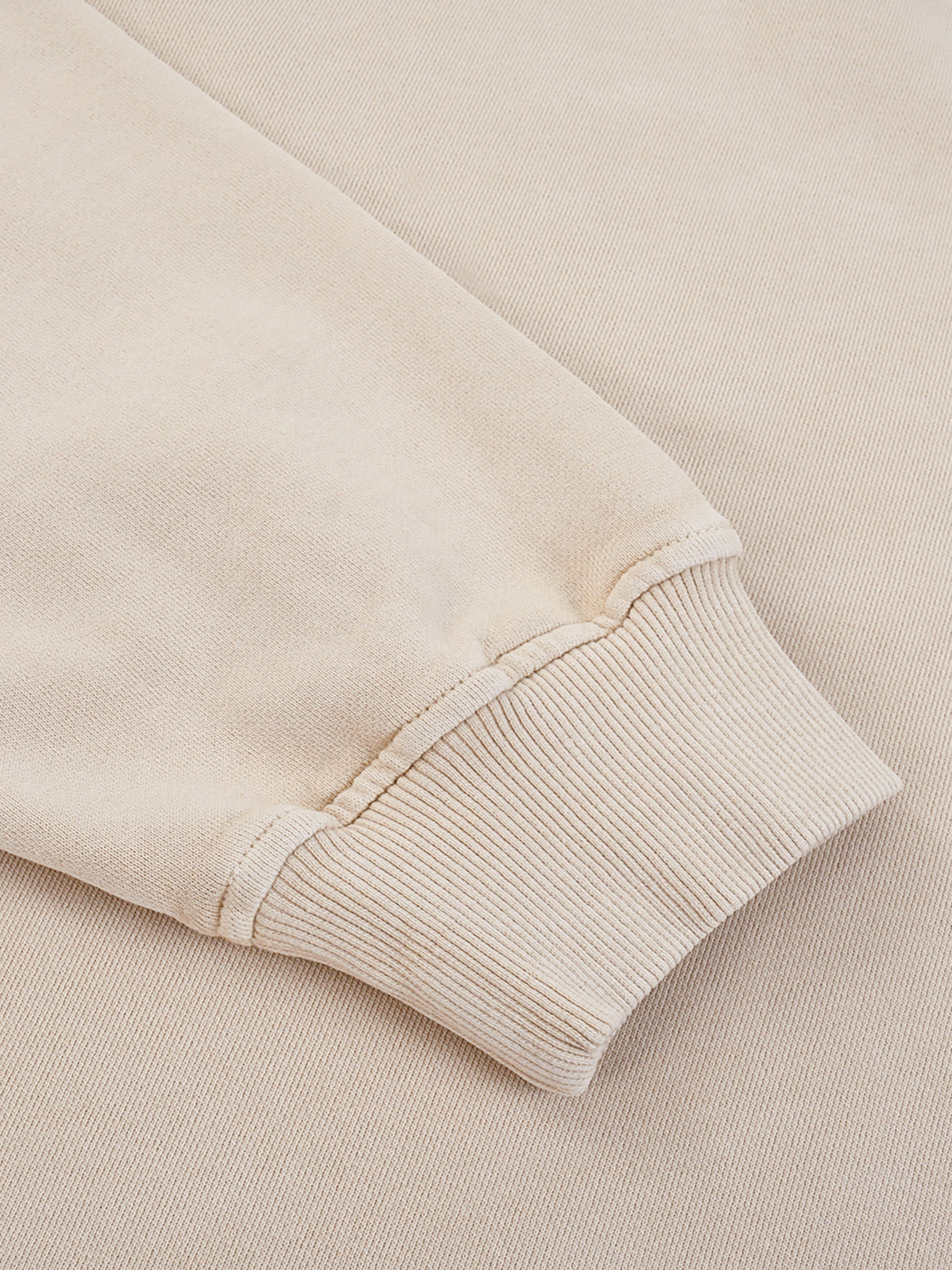 ODMPOD Snow Washed Oversized Sweatshirt displayed on a hanger, showing its relaxed fit and faded, vintage-inspired fabric texture.