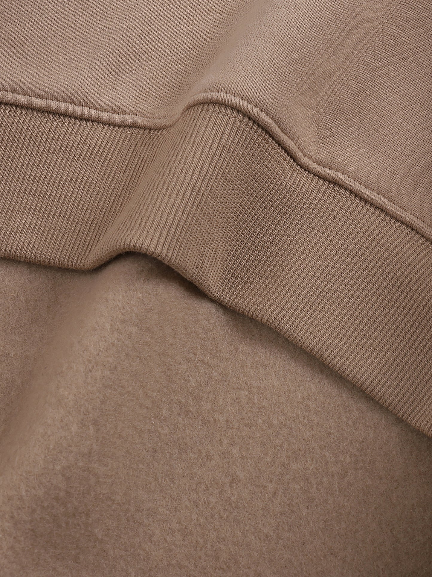 ODMPOD fleeced sweatshirt, cozy long-sleeve pullover with soft fleece lining and casual fit, in a neutral color.