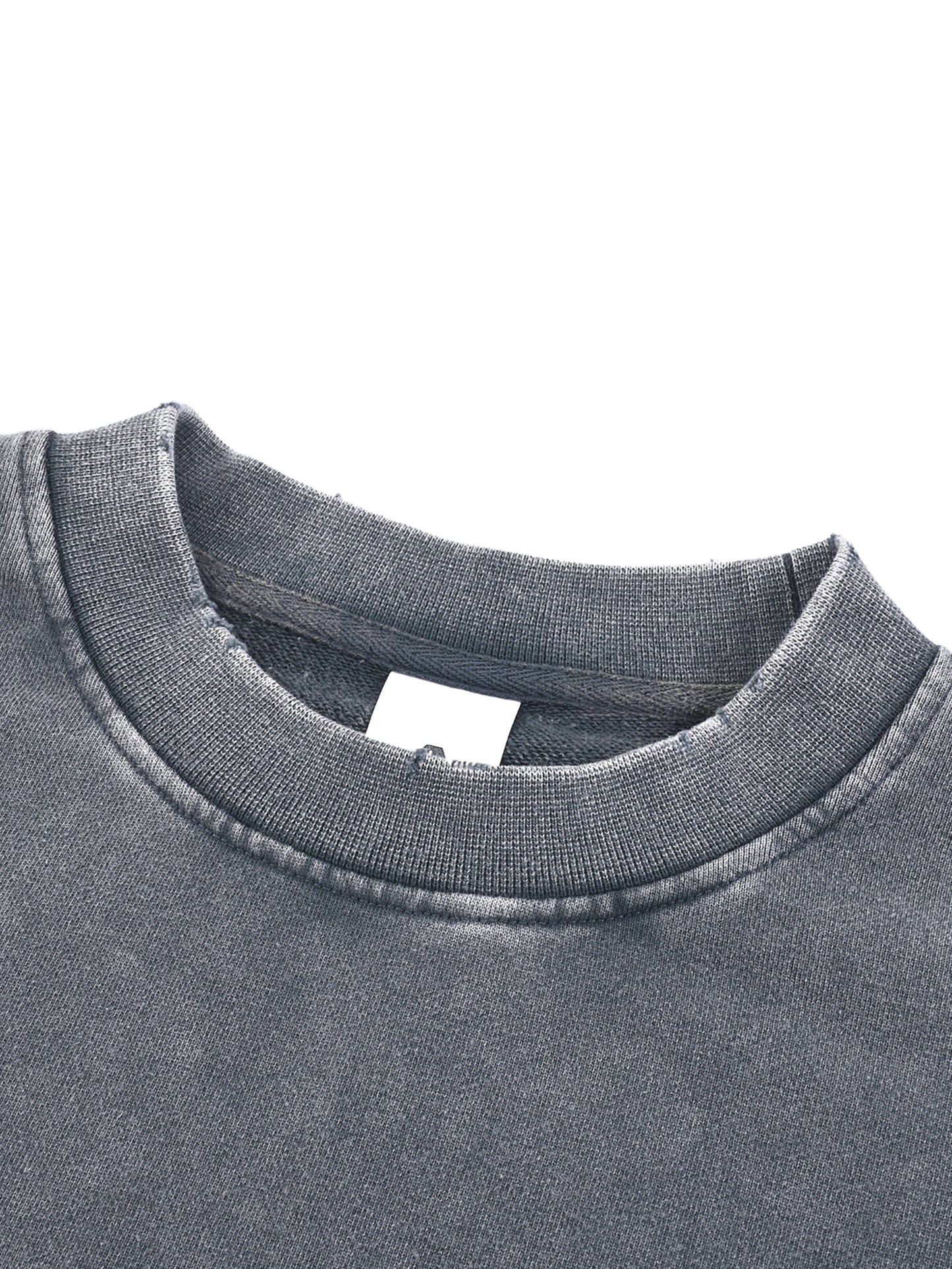 ODMPOD Snow Washed Raw Edge Cropped Sweatshirt displayed on a model showing its relaxed fit and distressed raw hem.