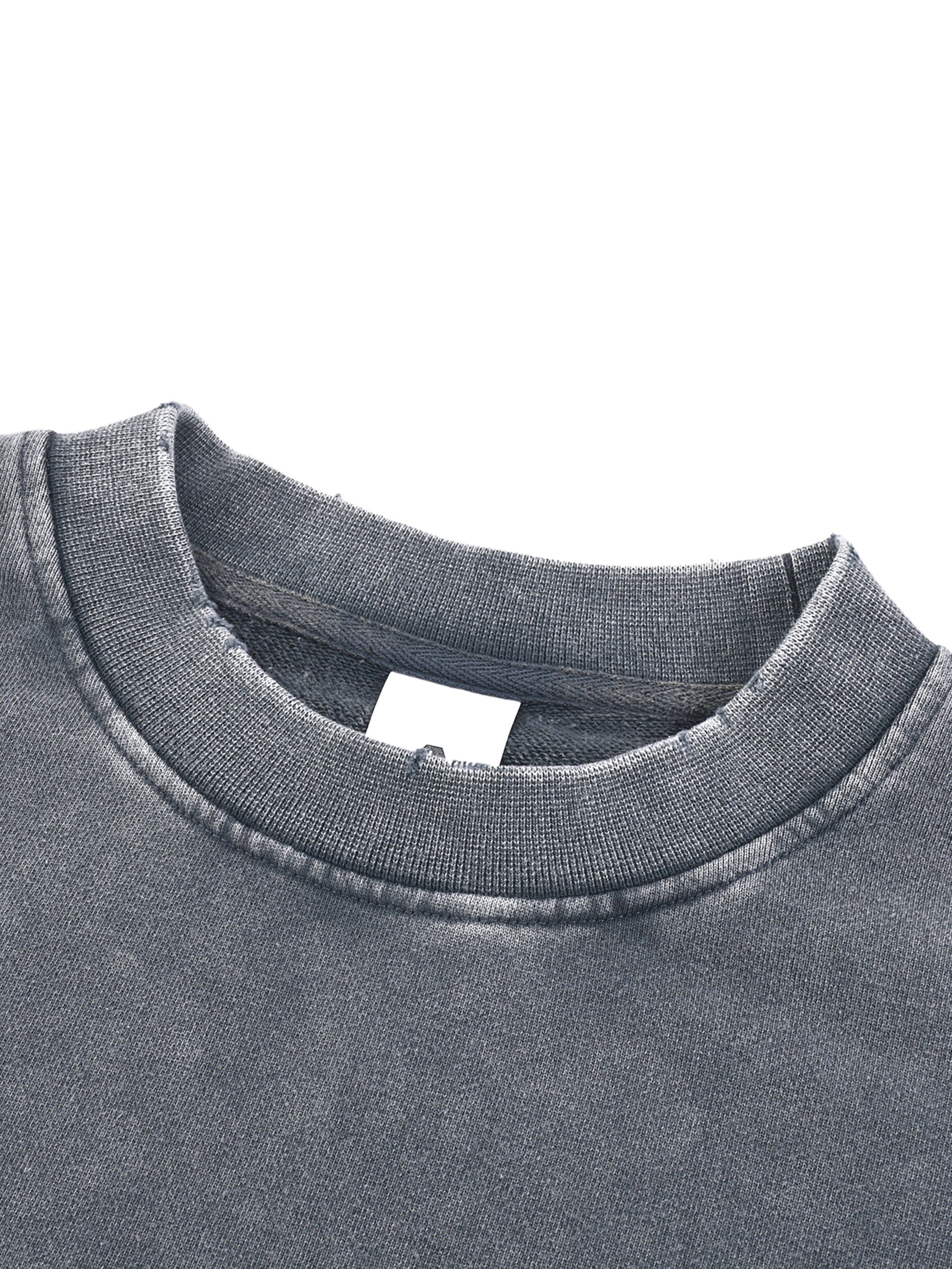 ODMPOD Snow Washed Raw Edge Cropped Sweatshirt displayed on a model showing its relaxed fit and distressed raw hem.