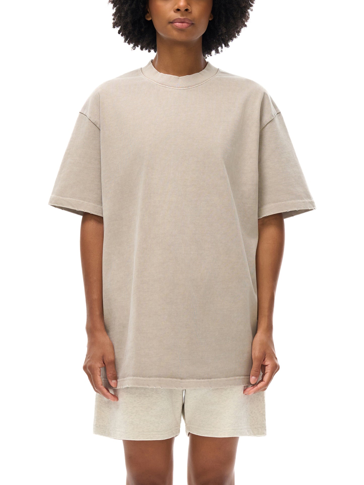 Heavyweight vintage washed frayed T-shirt by ODMPOD, featuring a distressed look and casual fit, displayed on a plain background.