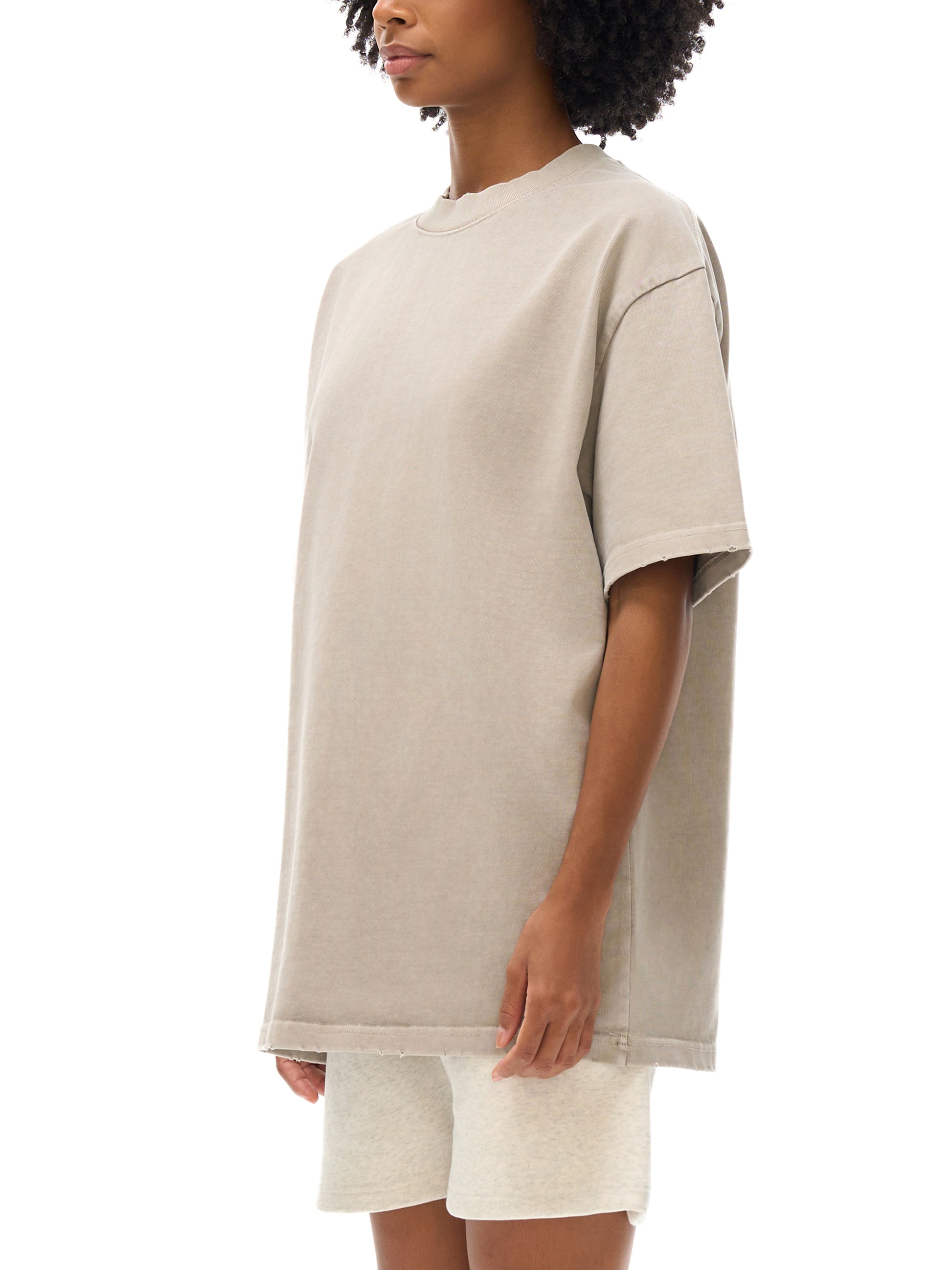 Vintage washed heavyweight ODMPOD T-shirt with frayed edges, showcasing a relaxed fit and distressed fabric detail.