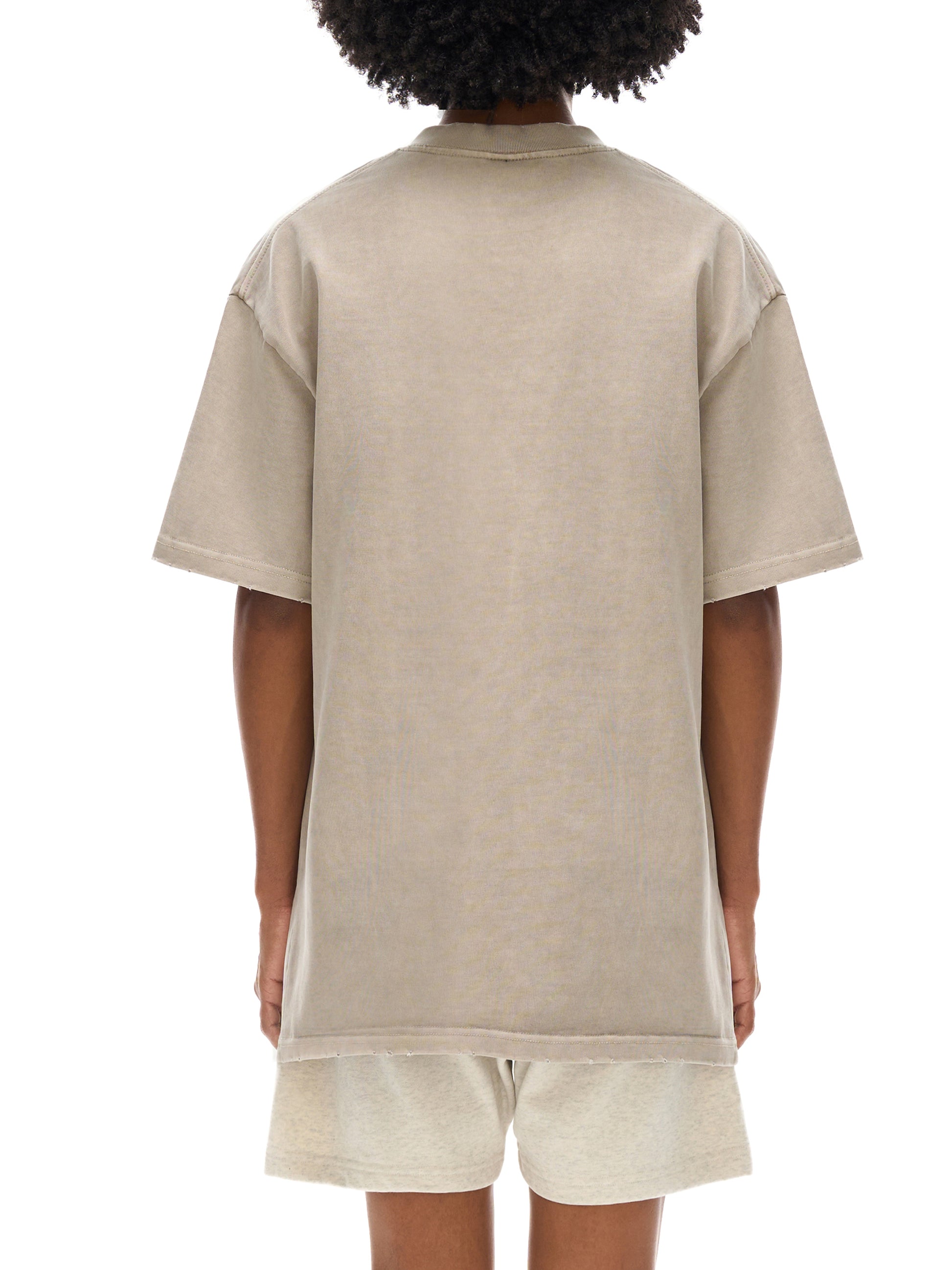 Vintage washed heavyweight T-shirt by ODMPOD with frayed edges, showcasing a relaxed fit and distressed design.