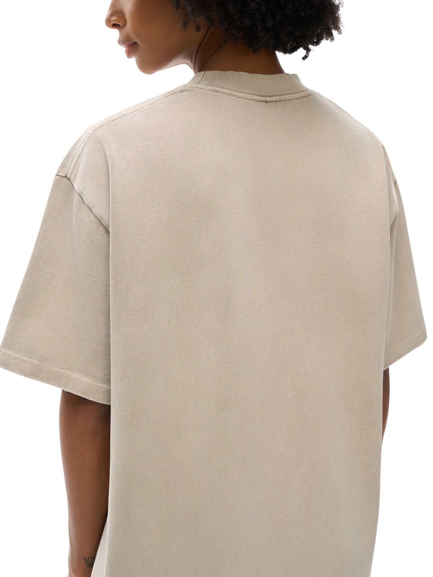 ODMPOD heavyweight vintage washed frayed T-shirt displayed hanging, showcasing distressed fabric and casual style.
