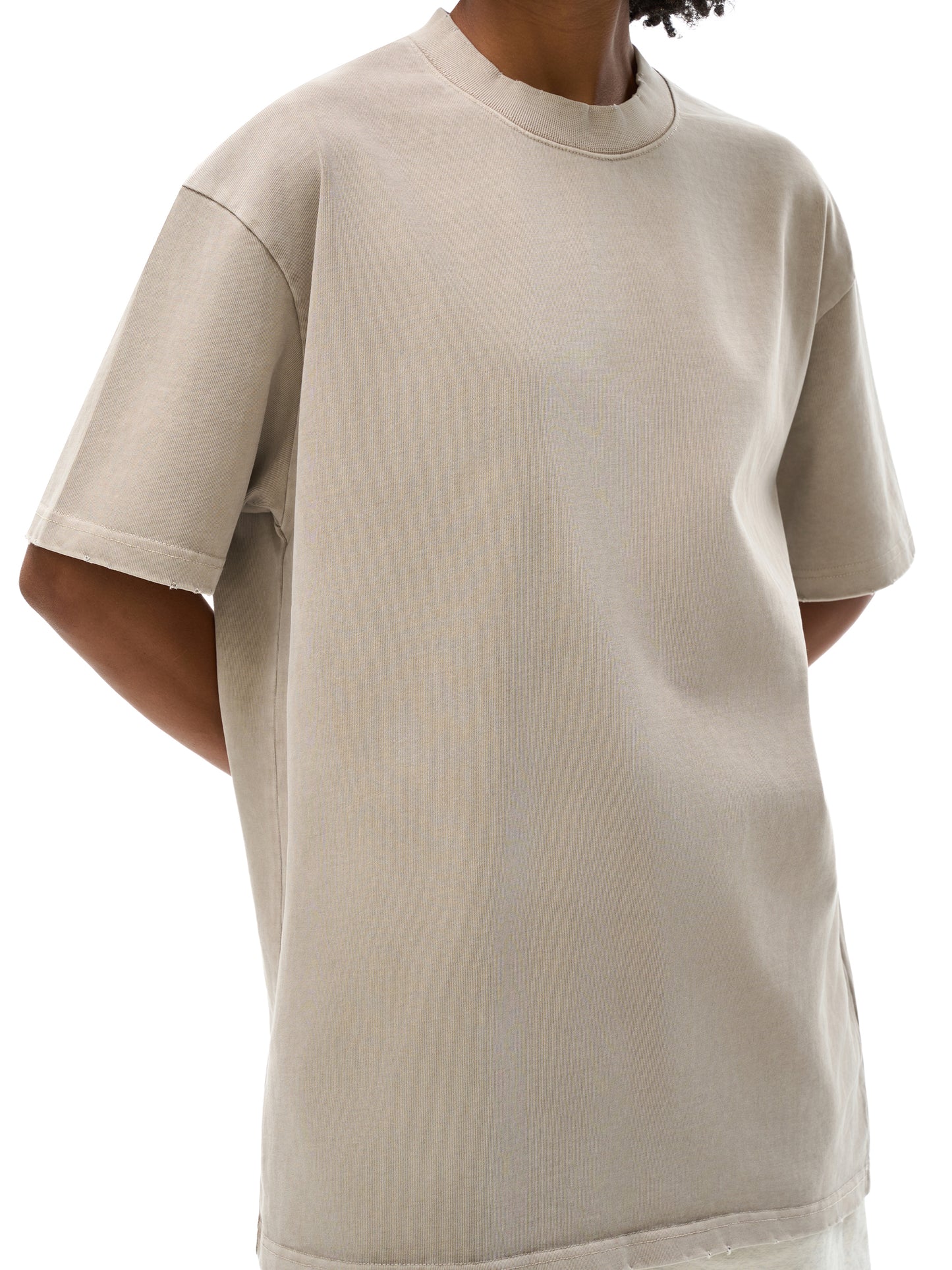 ODMPOD heavyweight vintage washed frayed T-shirt displayed flat, showcasing its distressed fabric and casual style.