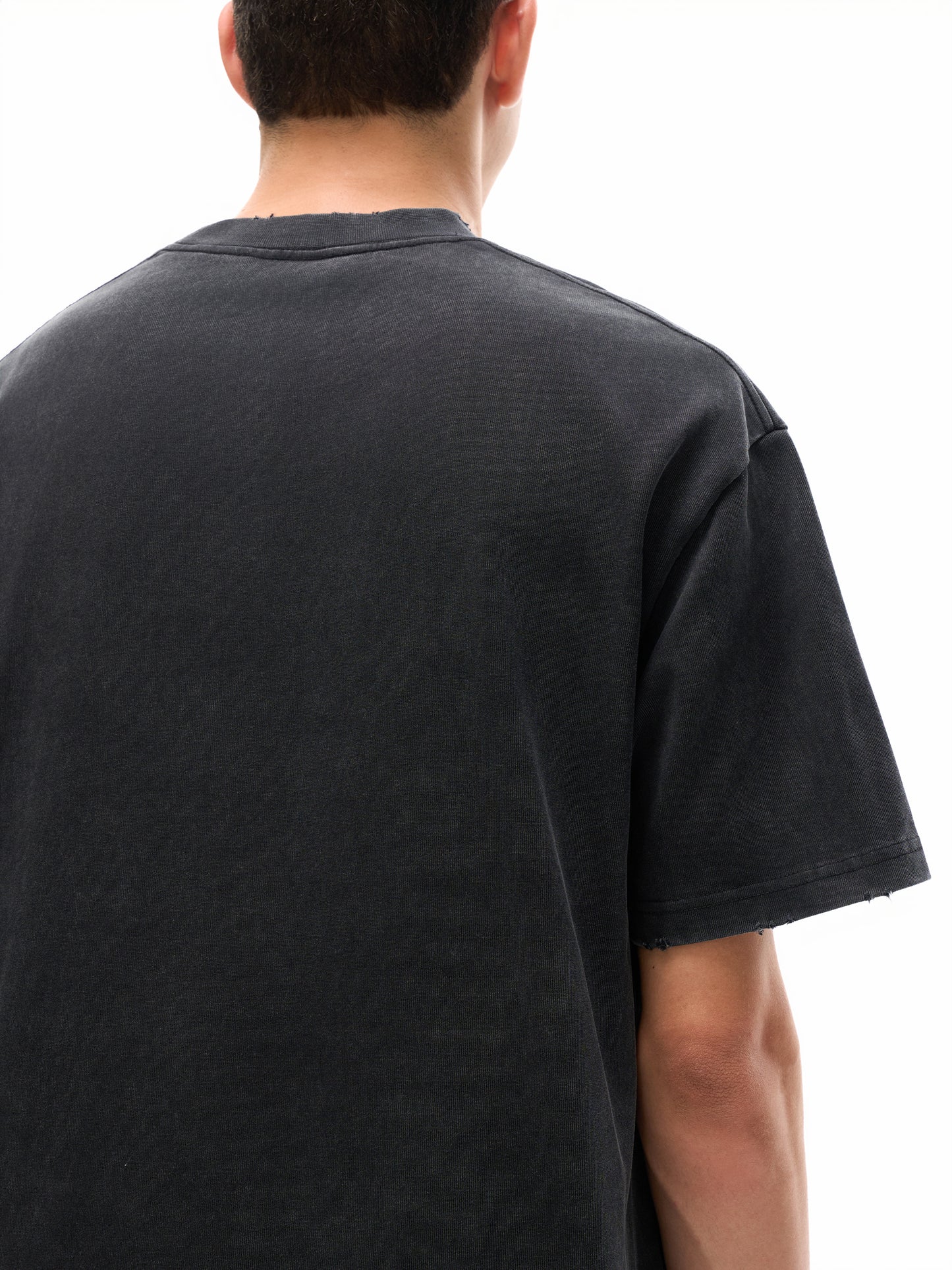 Heavyweight vintage washed frayed T-shirt by ODMPOD, showing a relaxed fit with distressed edges and a faded, worn-in look.