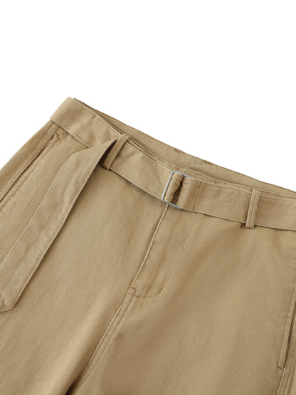 ODMPOD belted barrel-leg chino pants in beige, featuring a relaxed fit and front pockets, laid flat on a neutral background.