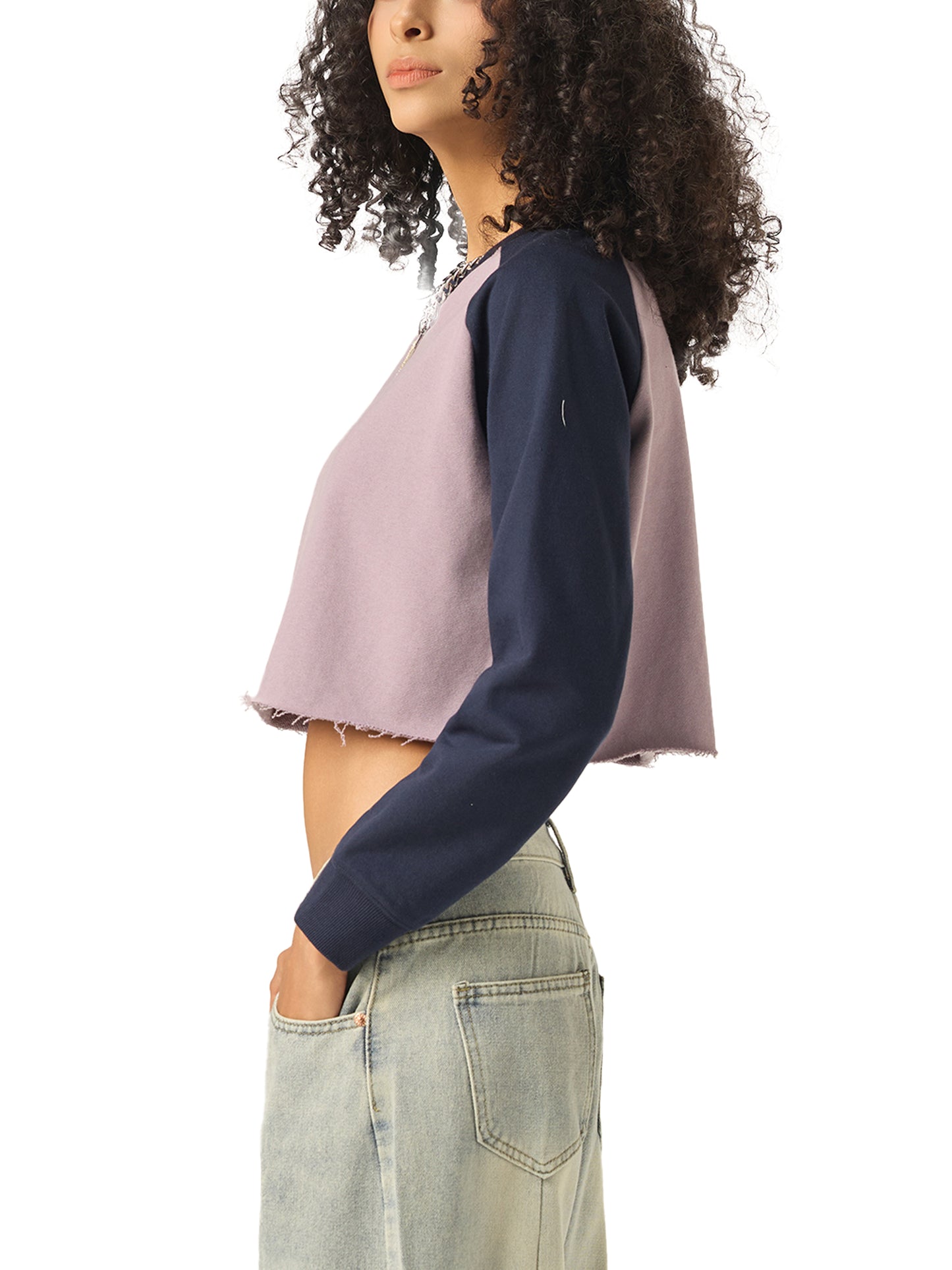 ODMPOD raw-hem color-block raglan crop sweatshirt showing a relaxed fit with contrasting color panels and raw hem detailing.