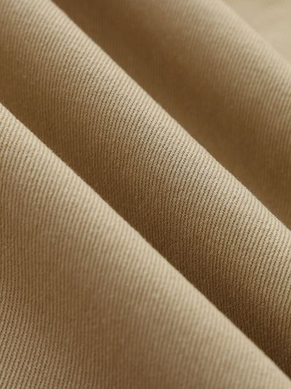 ODMPOD belted barrel-leg chino pants in khaki with front pockets and a relaxed fit, displayed on a hanger.