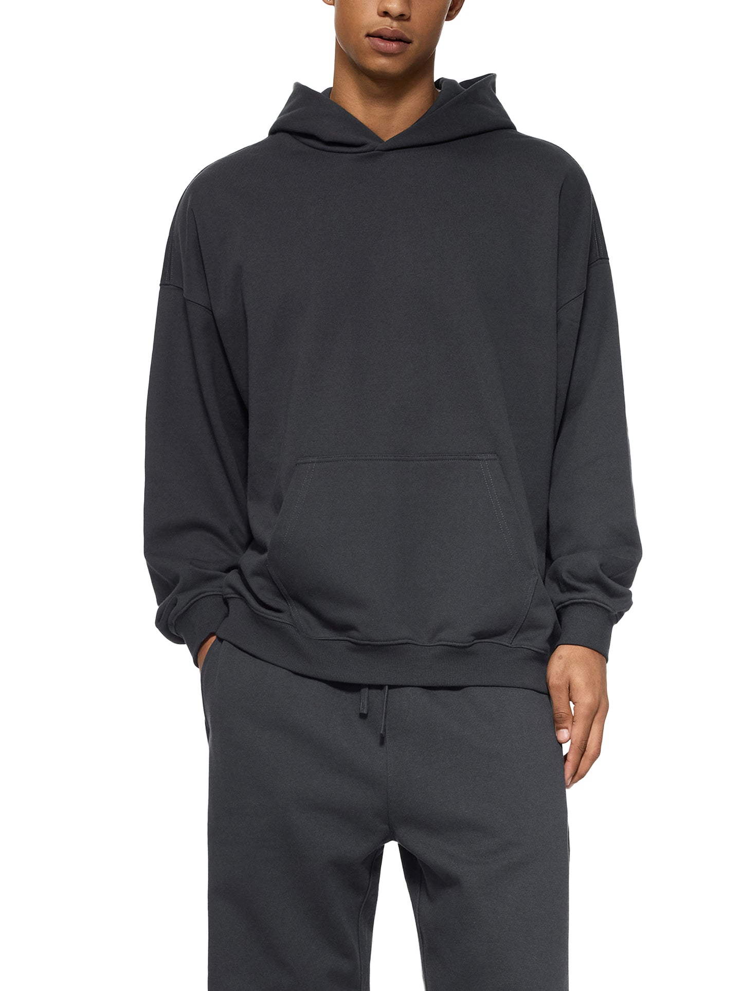 ODMPOD Essential Heavyweight Hoodie in black, showcasing a cozy, thick fabric with a front pocket and hood for casual comfort.