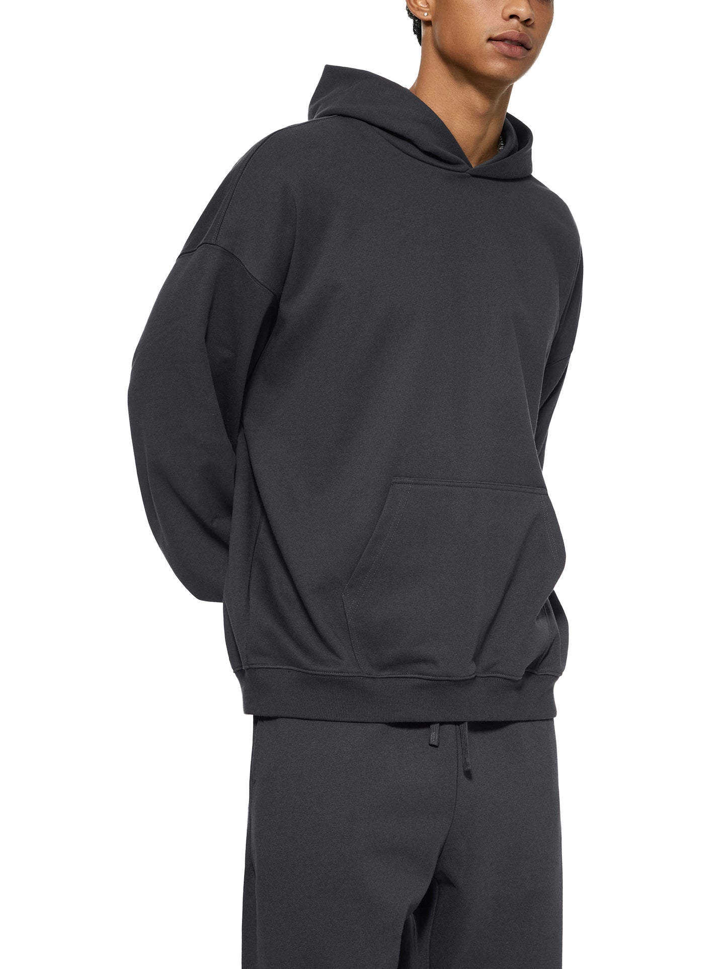 ODMPOD Essential Heavyweight Hoodie showing front view with hood and drawstrings, in a neutral color, soft fabric texture visible.