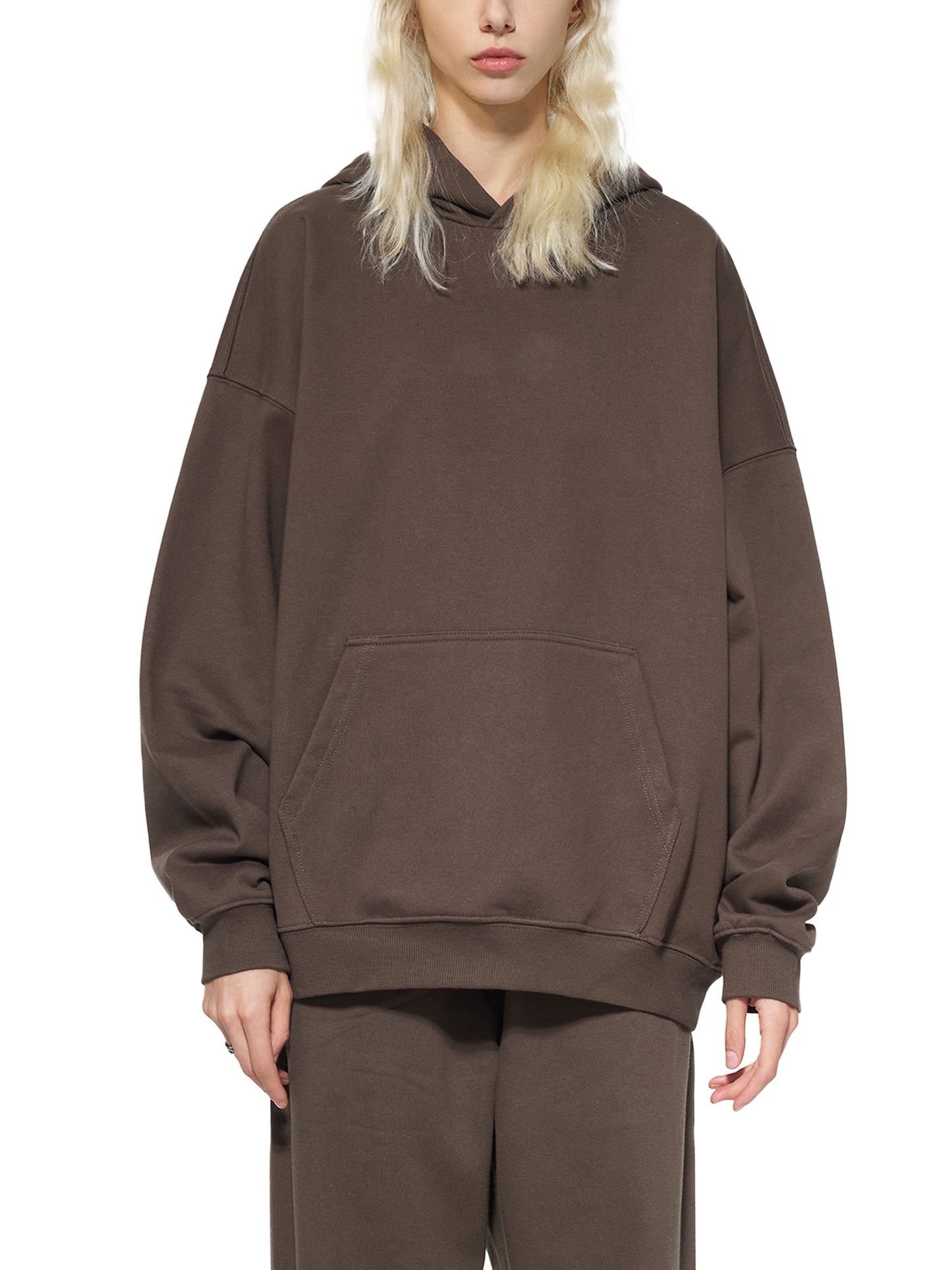 ODMPOD Essential Heavyweight Hoodie in gray with a front pocket, shown on a model against a neutral background.