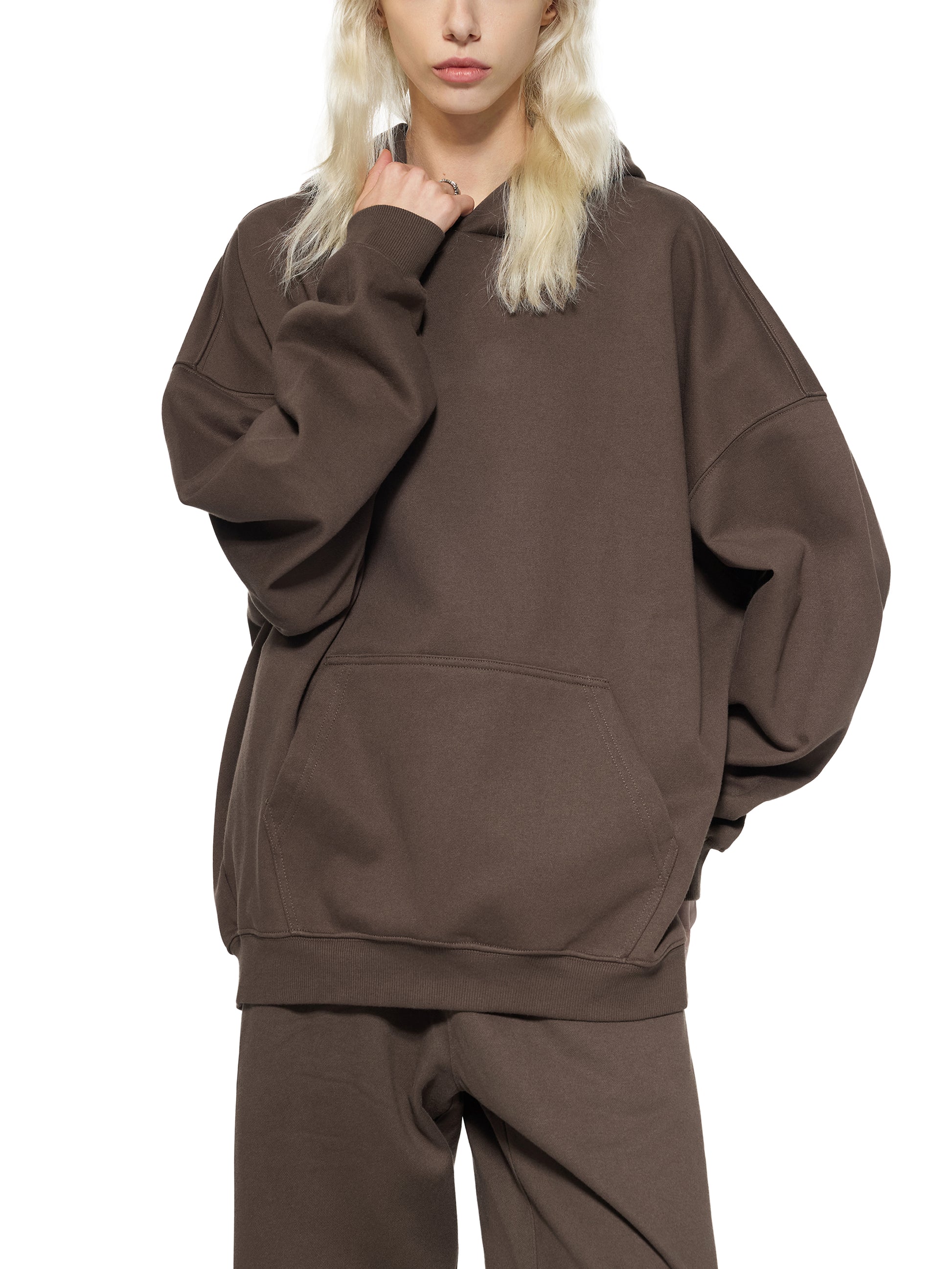 ODMPOD Essential Heavyweight Hoodie displayed on a hanger, showing its soft, thick fabric and relaxed fit in a neutral color.