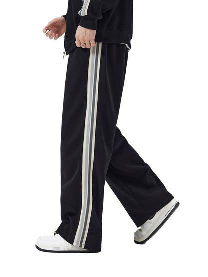 ODMPOD contrast side-stripe straight-leg pants displayed on a hanger, showcasing their stylish design and slim fit.