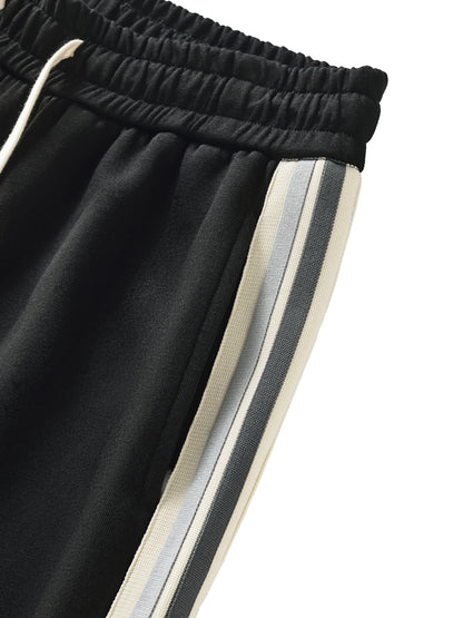 ODMPOD contrast side-stripe straight-leg pants shown flat with detailed view of the fabric and side stripe design.