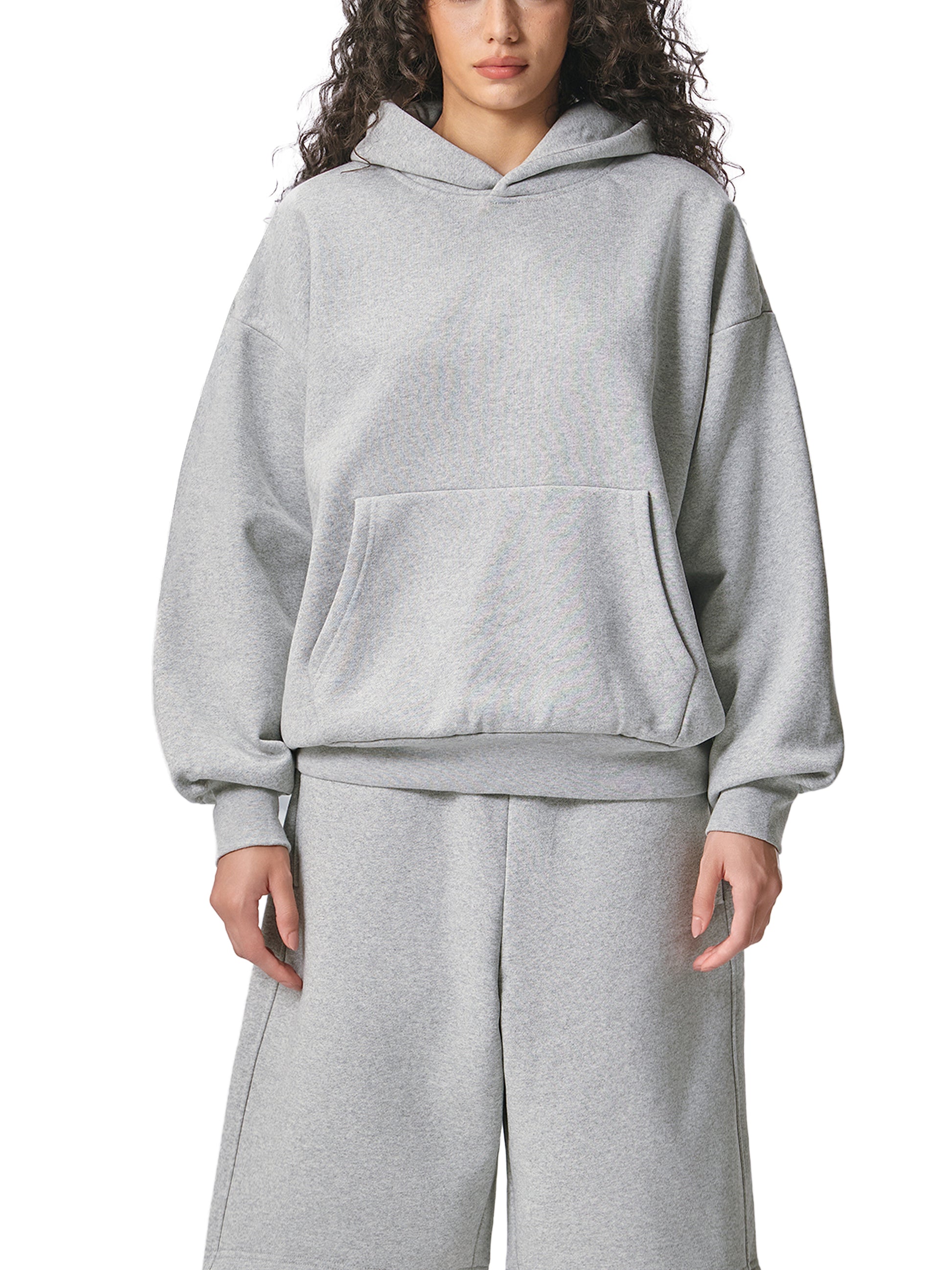 ODMPOD Essential heavyweight fleece hoodie in black, showing front view with hood and long sleeves.