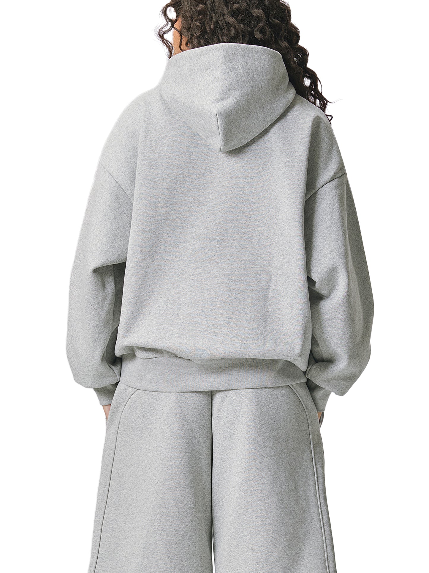 ODMPOD Essential Heavyweight Fleece Hoodie showing a cozy, thick fabric hoodie with a front pocket and drawstrings.