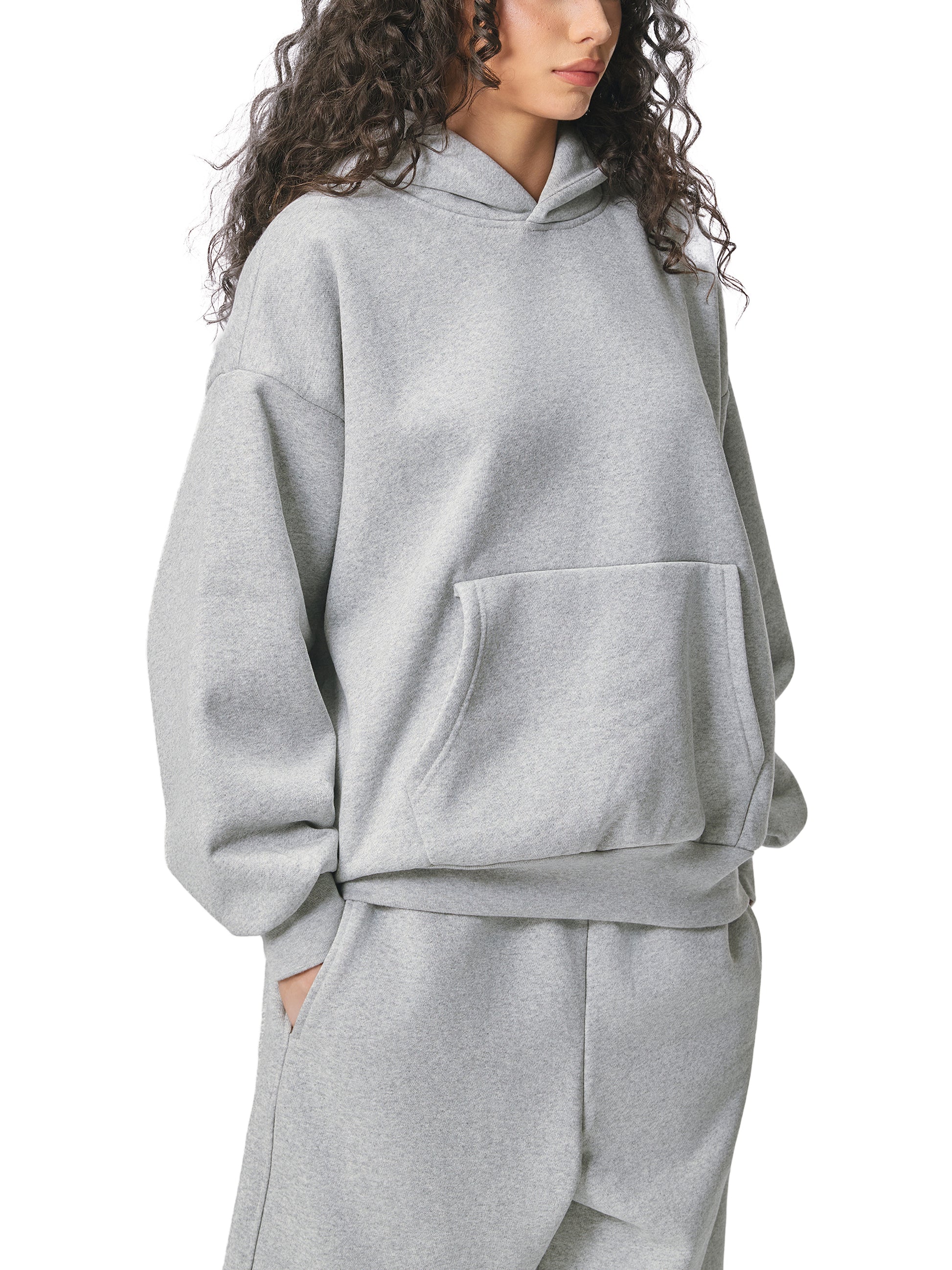 ODMPOD Essential heavyweight fleece hoodie, black with front kangaroo pocket and drawstring hood, soft and cozy for casual wear.