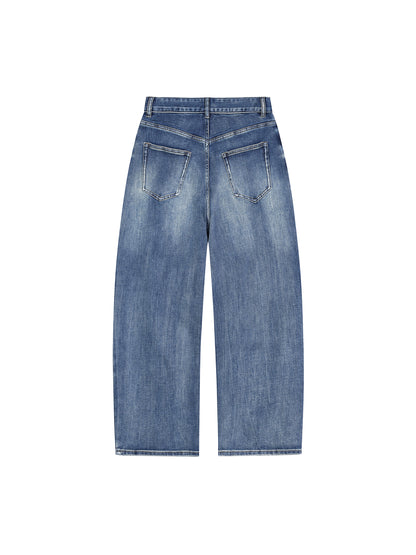 ODMPOD Sun Fade Heavyweight Denim Jeans, close-up of distressed blue jeans with sun fade details and sturdy denim fabric.