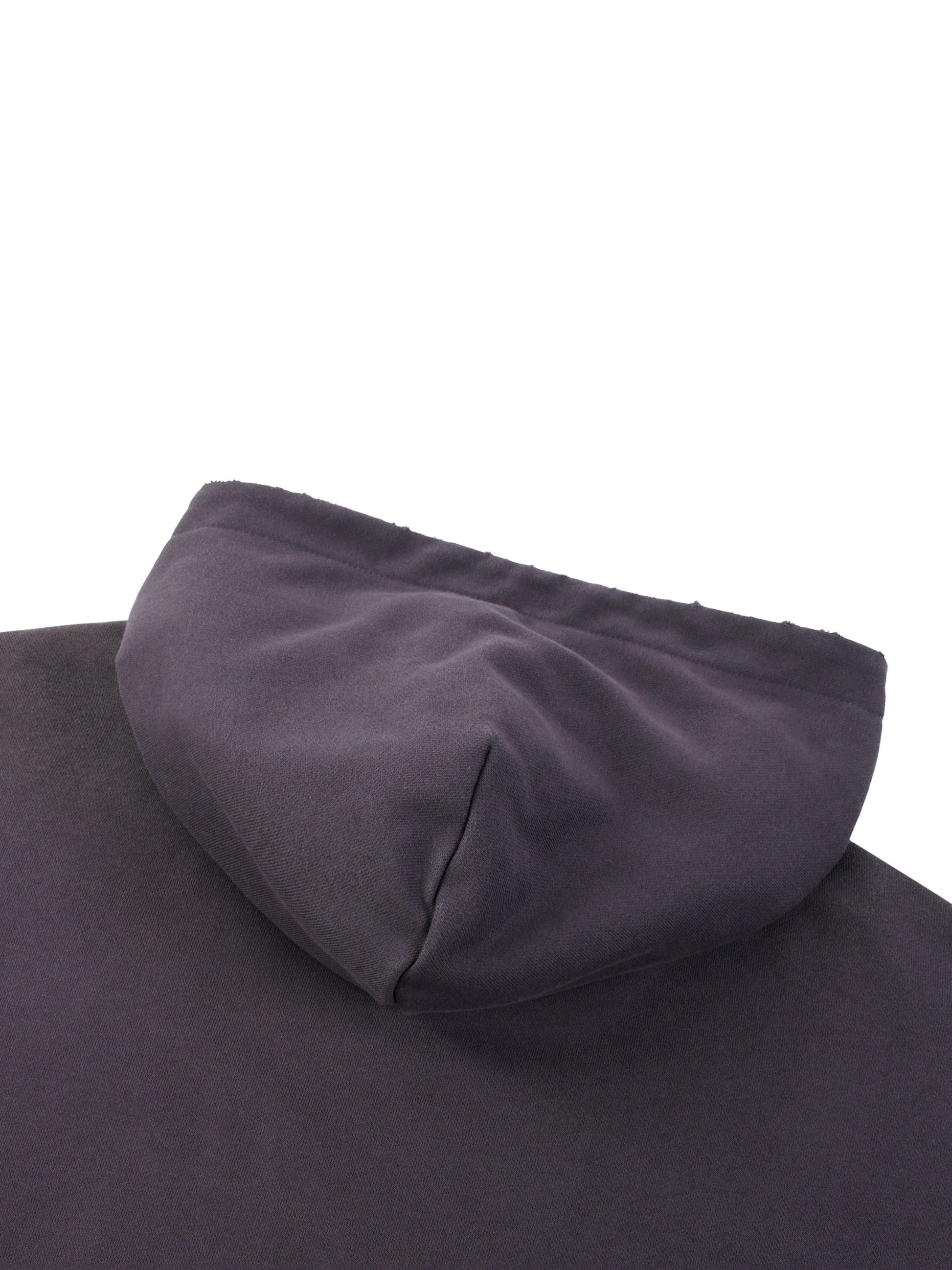 ODMPOD Sun Fade Frayed Fleece Hoodie, close-up of soft, distressed fabric with frayed edges and sun fade design.