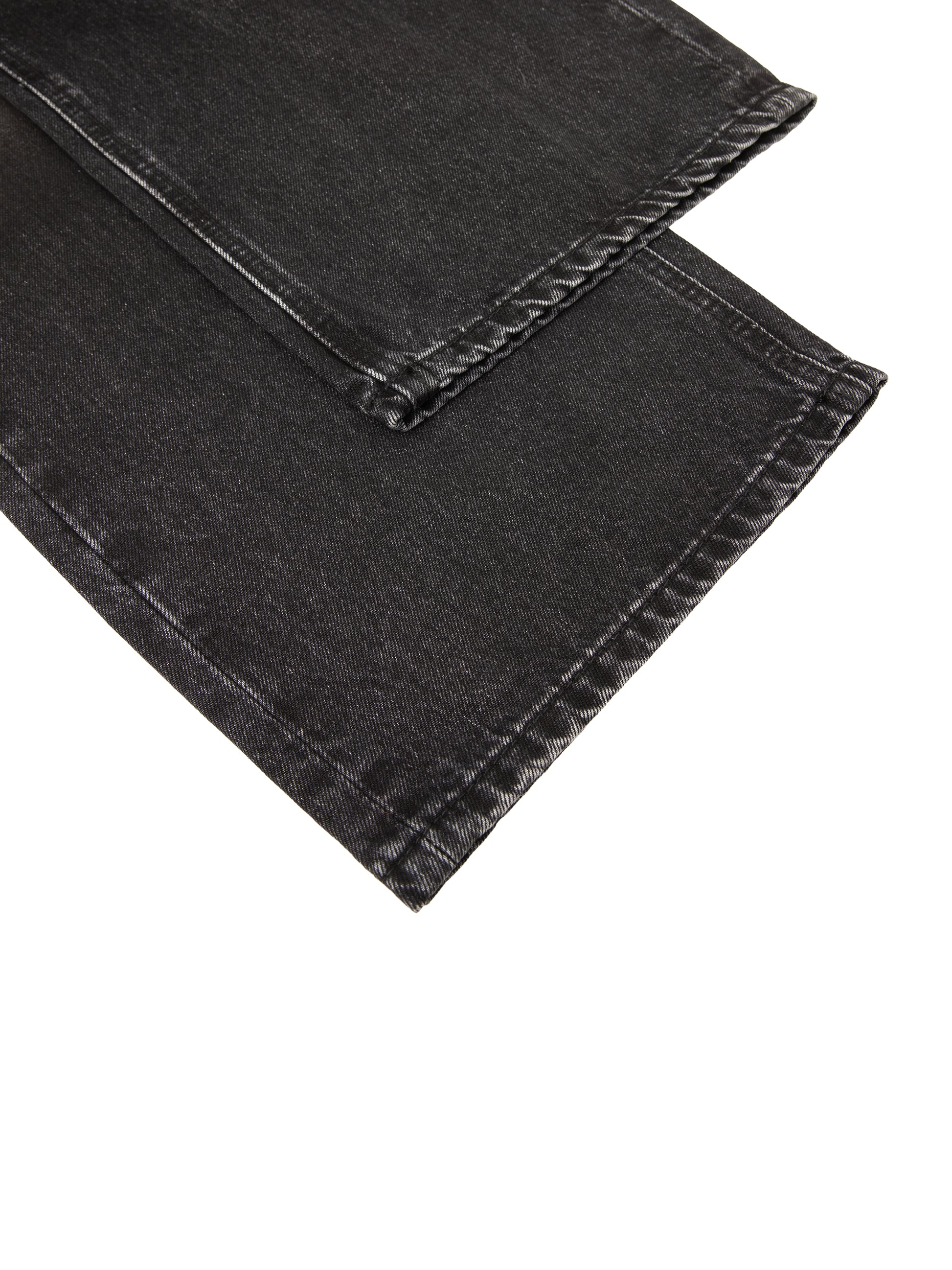 Vintage wash heavyweight denim jeans by ODMPOD, showing classic fit and distressed details in a natural pose.