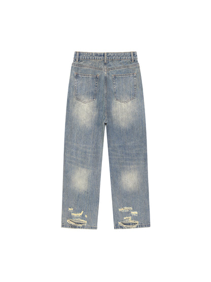 Vintage wash distressed denim jeans by ODMPOD featuring a classic fit, faded details, and a worn-in look.