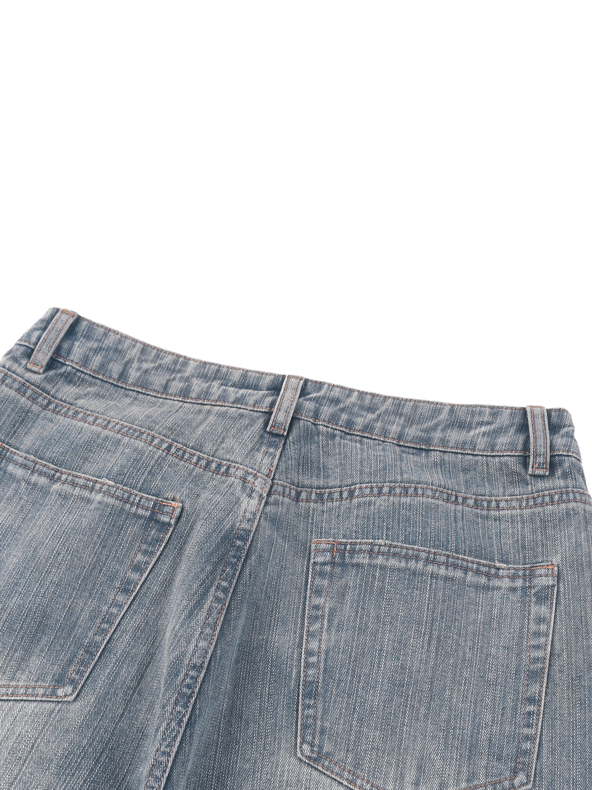 Vintage wash distressed denim jeans by ODMPOD, featuring a classic fit with intentional fading and frayed detailing.
