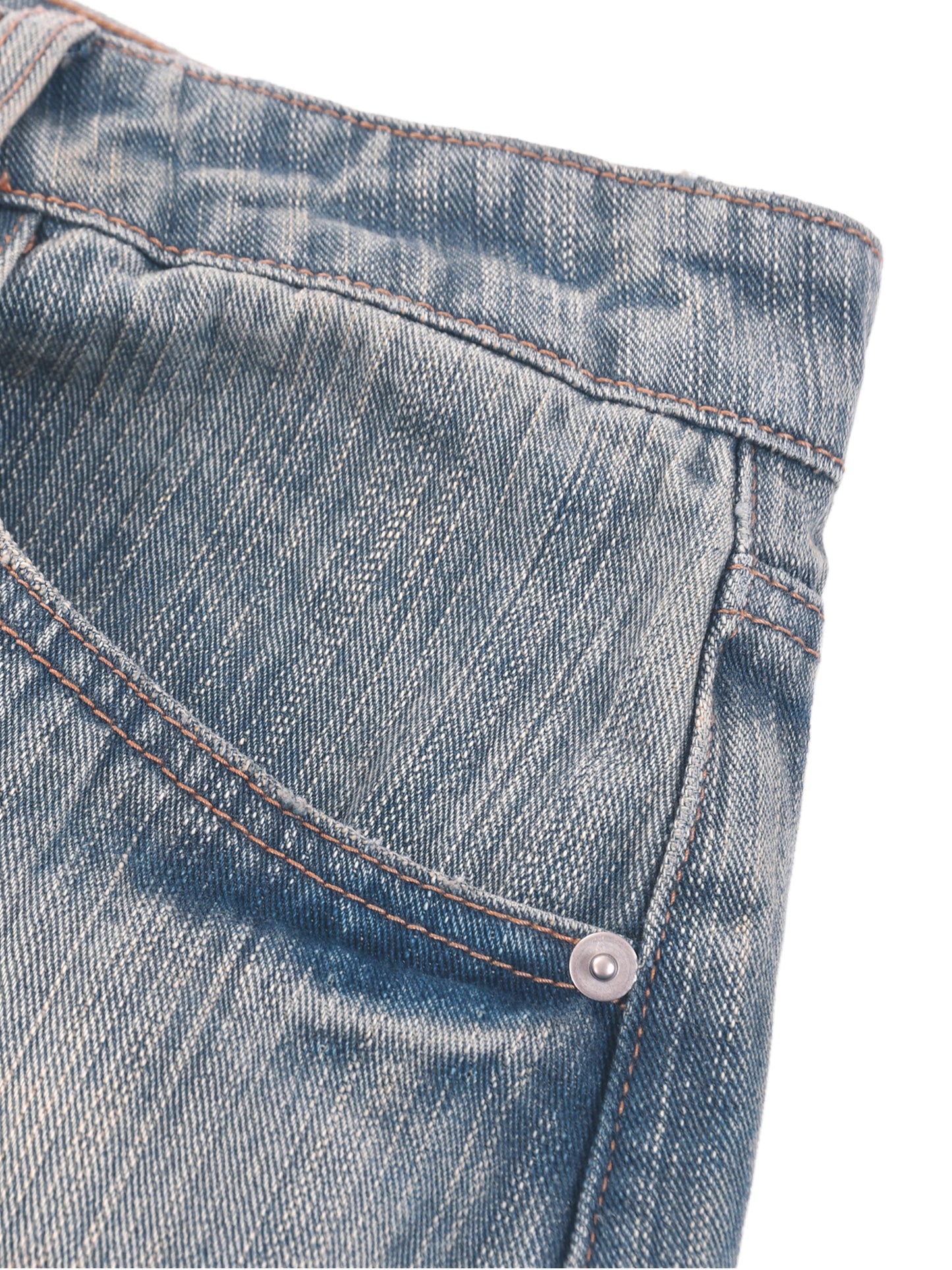 Vintage wash distressed denim jeans from ODMPOD, showing a close-up of the worn, faded fabric and stylish distressed details.