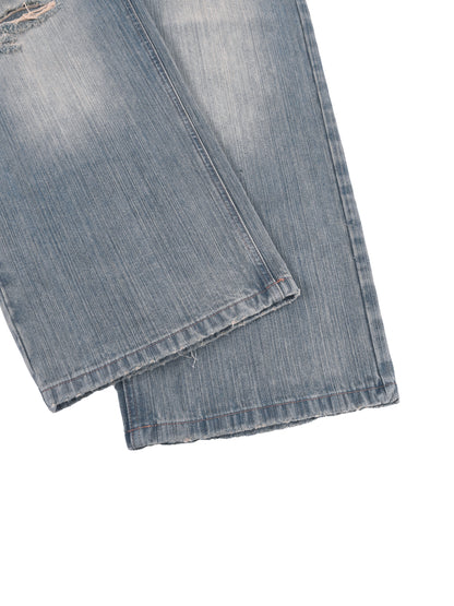 Vintage wash distressed denim jeans from ODMPOD featuring faded and ripped details, classic five-pocket style, and relaxed fit.