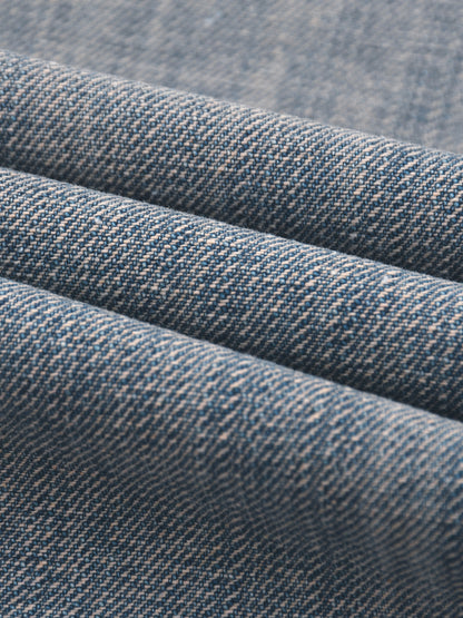 Vintage wash distressed denim jeans by ODMPOD, showing a close-up of the faded, ripped denim fabric and classic jean stitching.