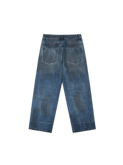 Vintage wash baggy denim jeans by ODMPOD, showing relaxed fit with faded blue denim and classic five-pocket design.